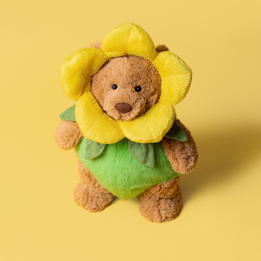 Kuscheltier-Bär mit gelbem Blütenkopf und grüner Blumenkleidung, frontal