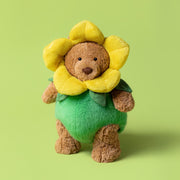 Kuscheltier-Bär mit gelbem Blütenkopf und grüner Blumenkleidung, sitzend