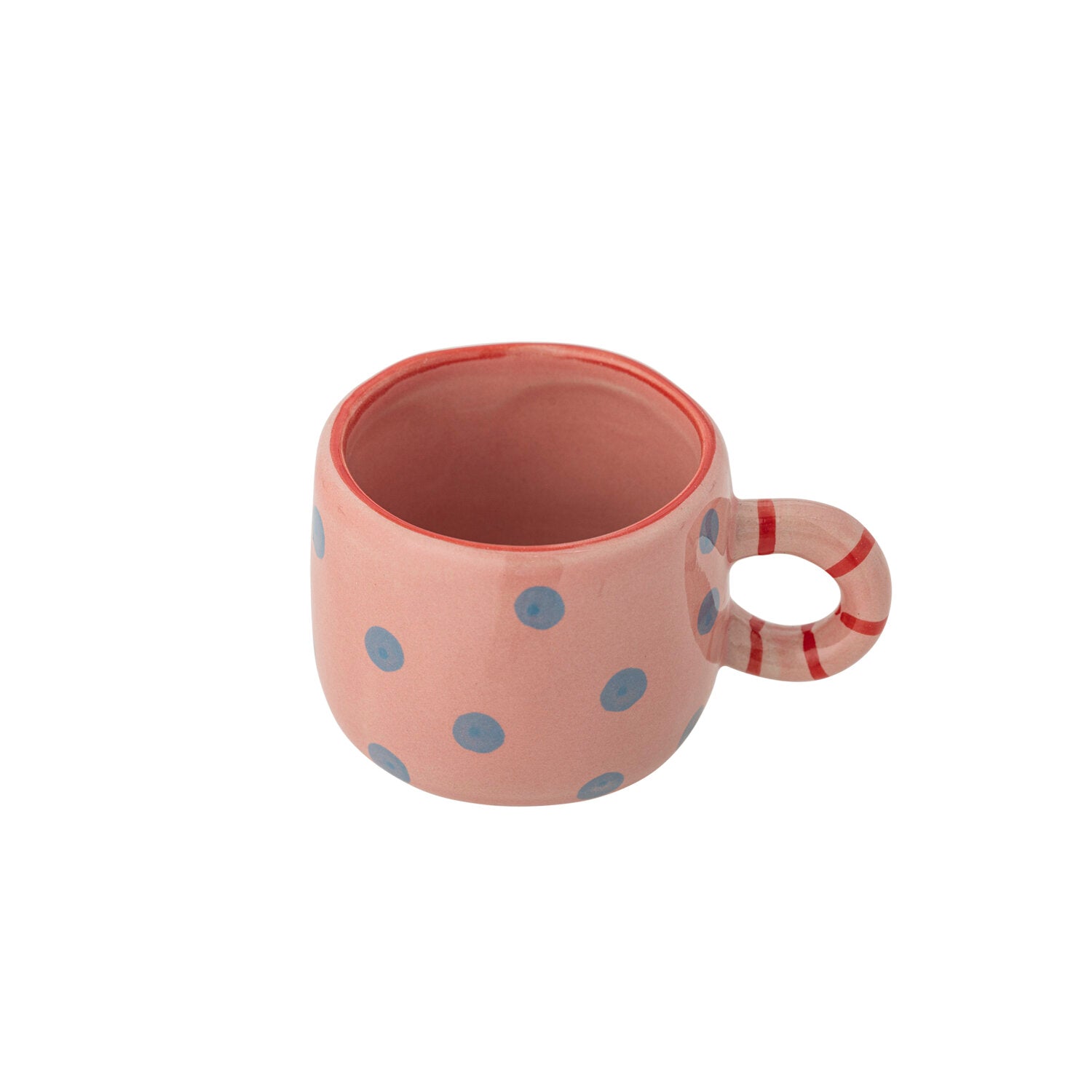 Rosa Tasse mit blauem Punktenmuster, innen dunkel, mit rot-weißem Henkel.