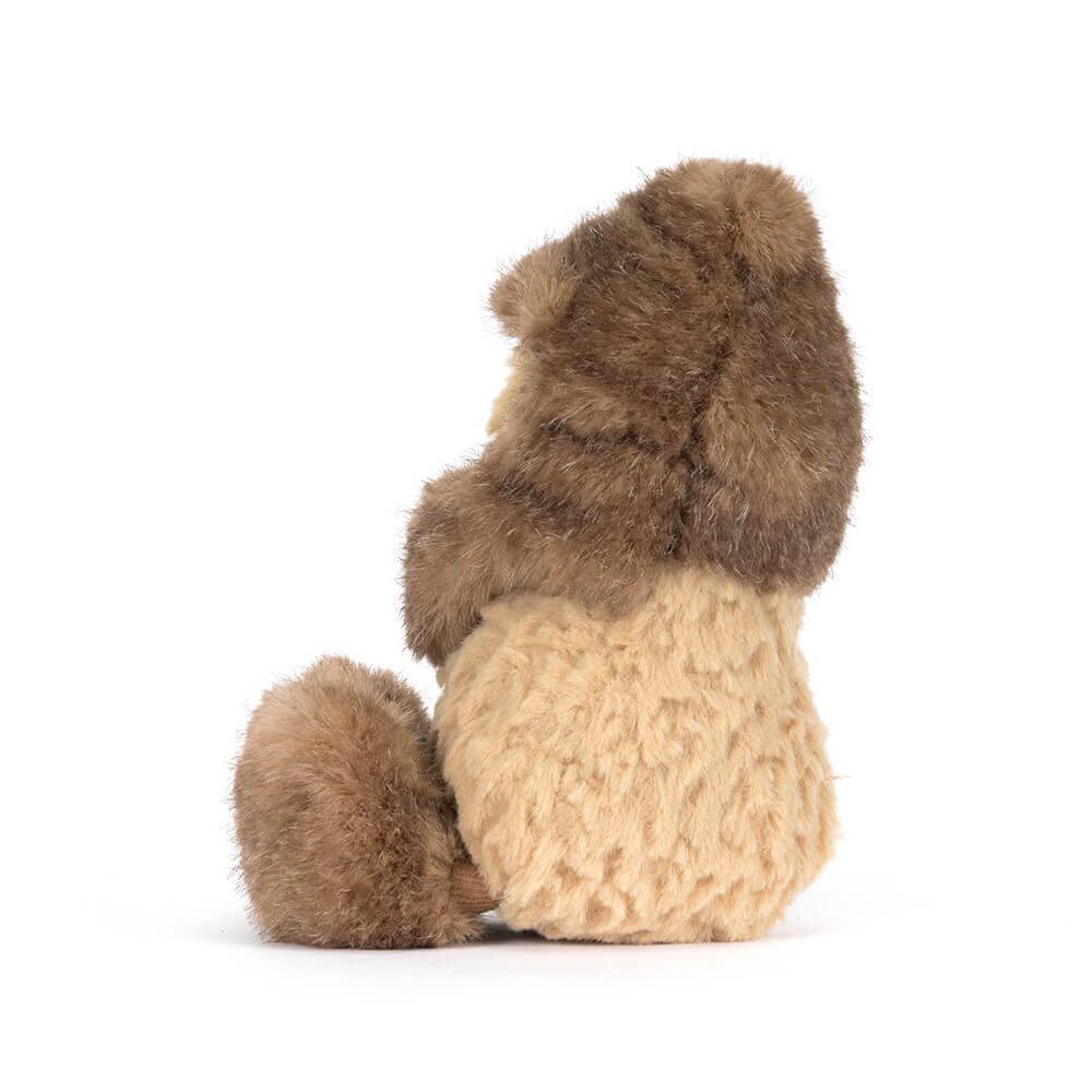 Braunes Plüschtier mit beigem Bauch und ausgestelltem Yeti-Outfit im Seitenprofil