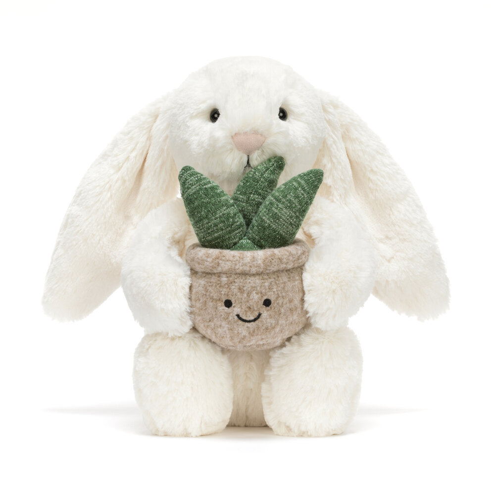 Kuscheltierhase in Creme mit grauem Pflanzentopf und grünen Blättern