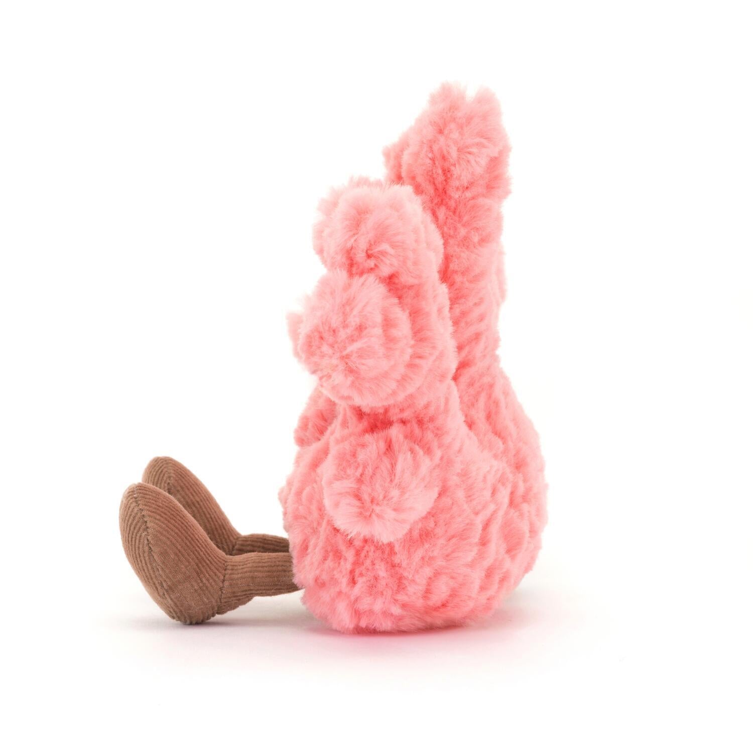 Kuscheltier Koralle, rosa Plüschfigur in Seitenansicht mit lächelndem Gesicht und braunen Beinen