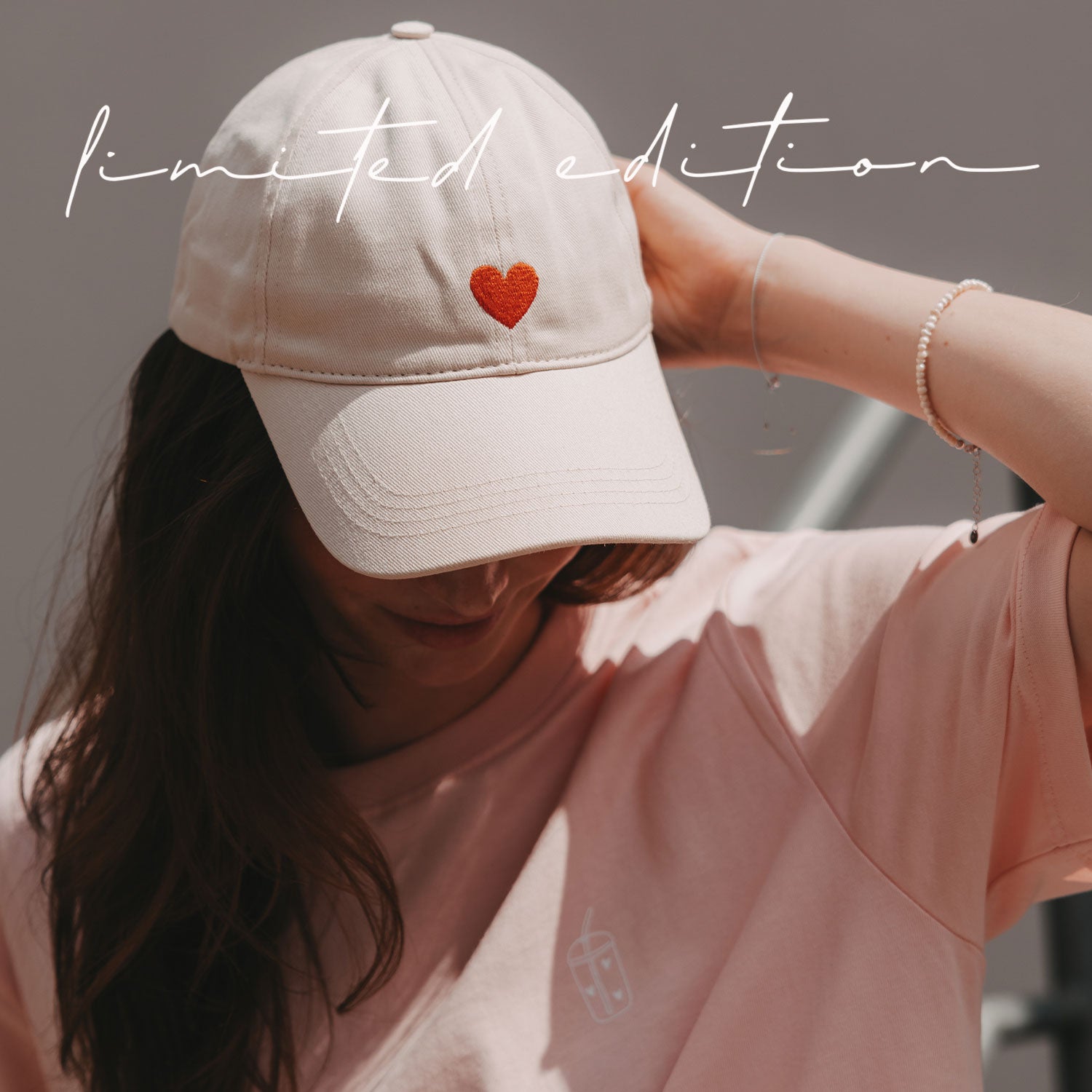 Beige Basecap, getragen; rotes Herz-Emblem auf der Vorderseite