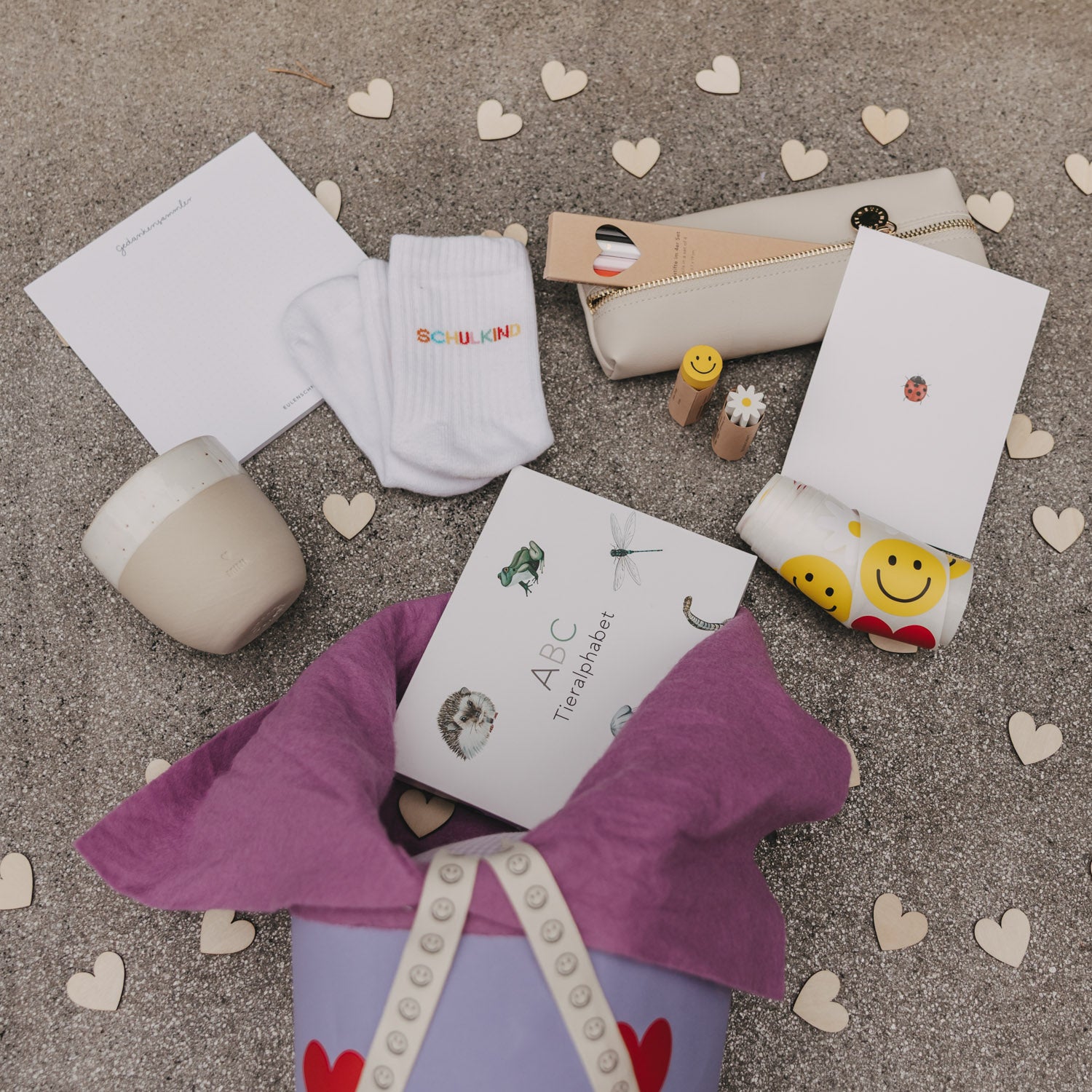 Set weißer Kindersocken mit „Schulkind“-Logo, gefaltet und auf dem Boden drapiert