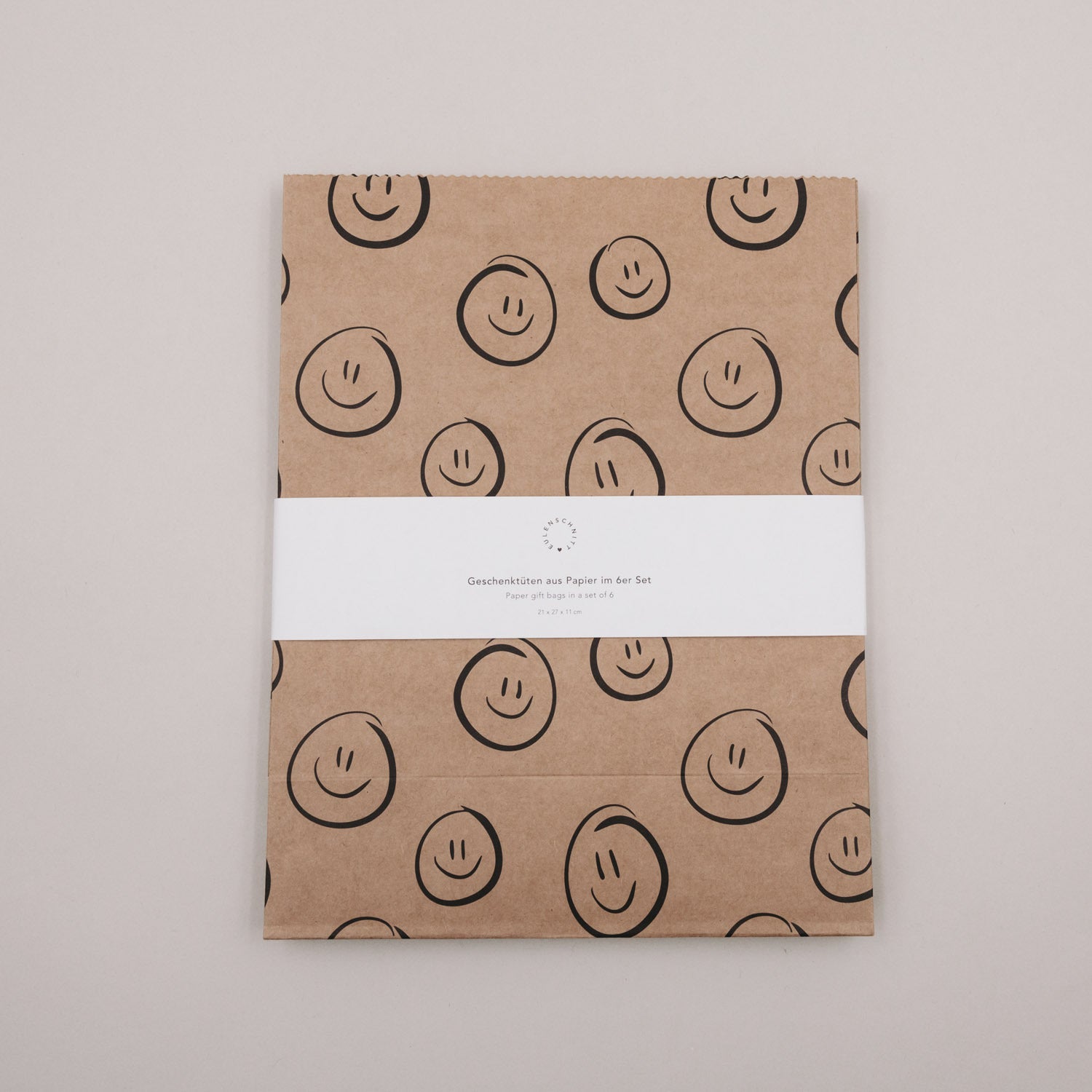 Papiertüte aus Kraftpapier mit lächelnden Smiley-Illustrationen